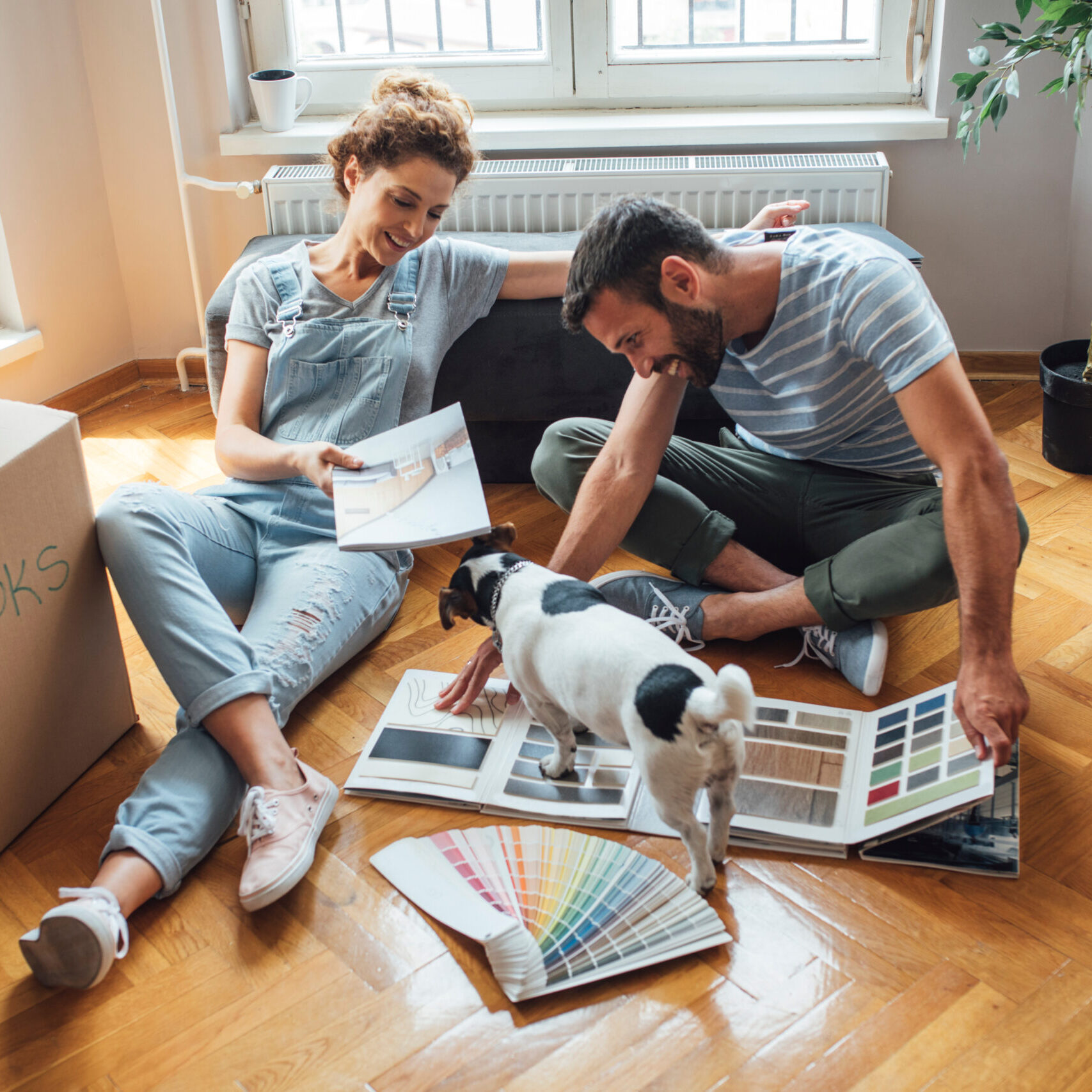 Husband and wife and their dog moving in new home.